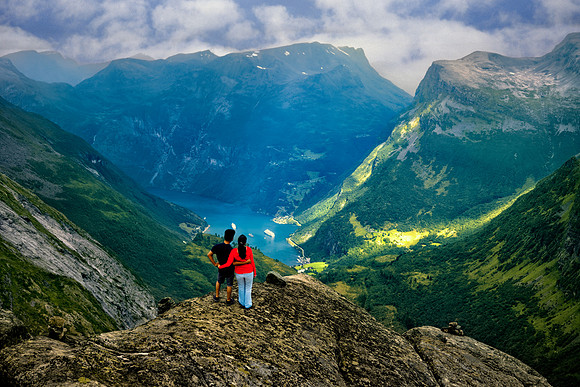 Couple Gaze At Geirangerfjord From High Viewpoint 2